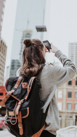 woman-taking-photo-of-high-rise-building-beside-road.jpg woman taking photo of high-rise building beside road